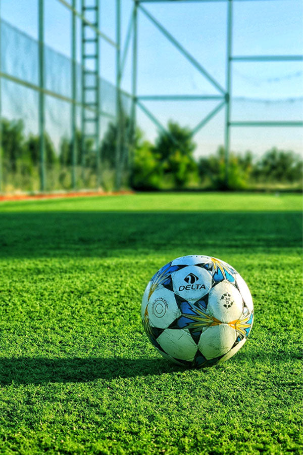 Artificial grass being installed in a garden – low-maintenance turf by PlantsWorld.ae