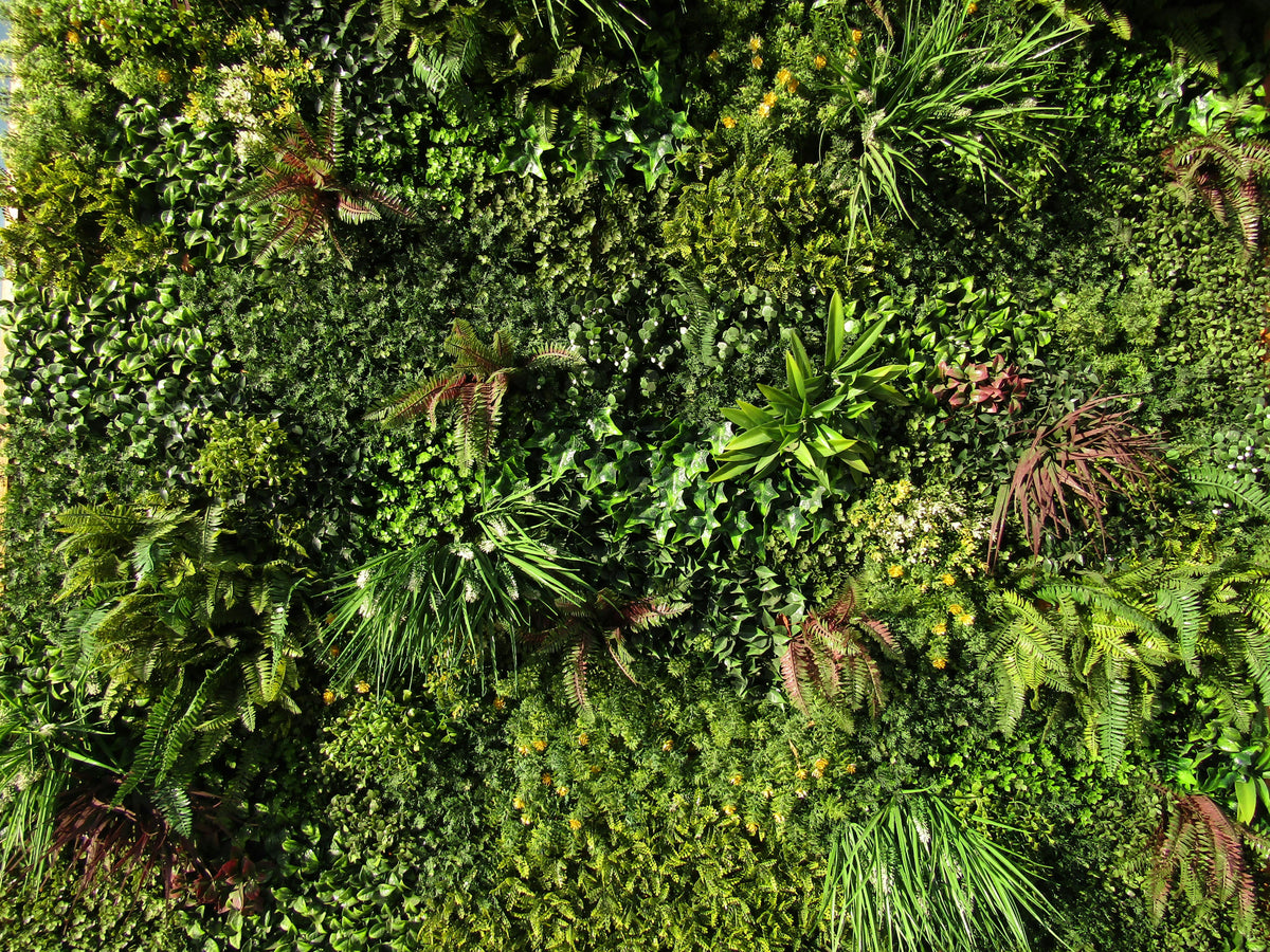 Lush vertical green wall garden on a Dubai building exterior with tropical plants