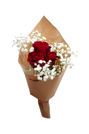 A small bouquet of three fresh red roses arranged for gifting